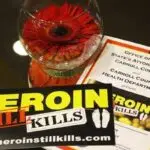 Brochure and bumper sticker saying Heroin Still Kills